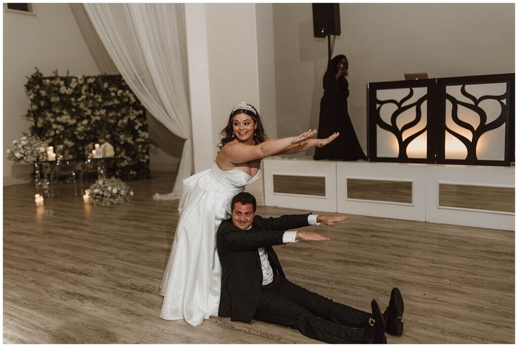 Bride and groom using their bodies to make the letter E during their first dance to L-O-V-E by Nat King Cole. 