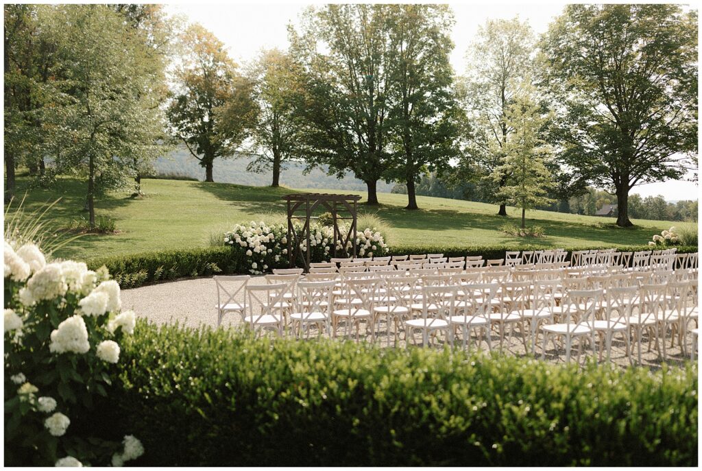 wedding ceremony space with white hydrangeas and white chairs