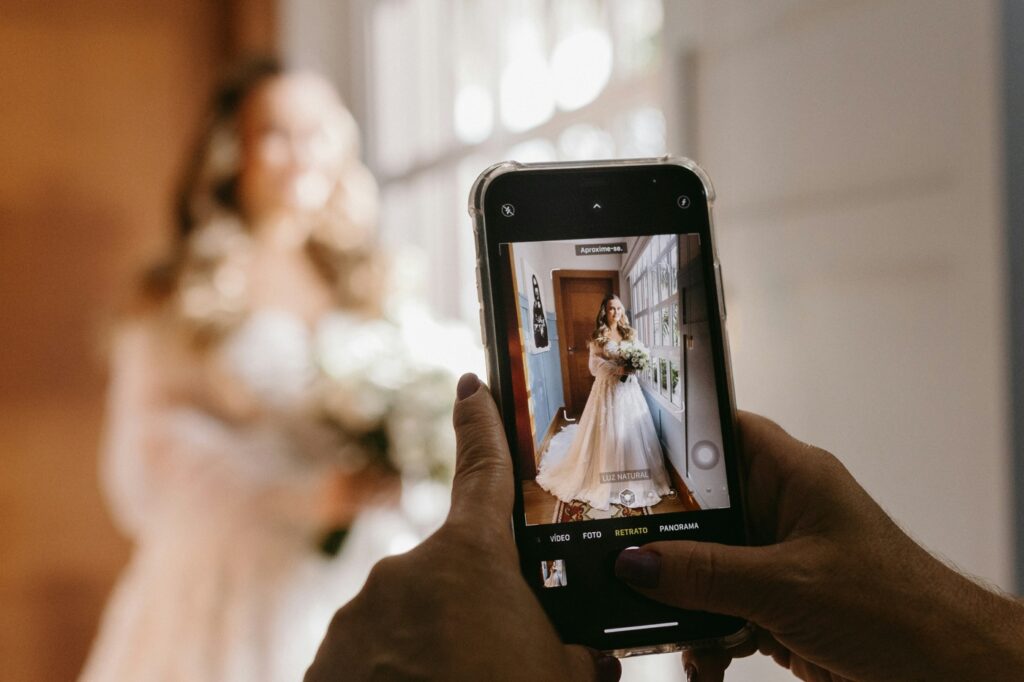 wedding content creator filming bride on cellphone