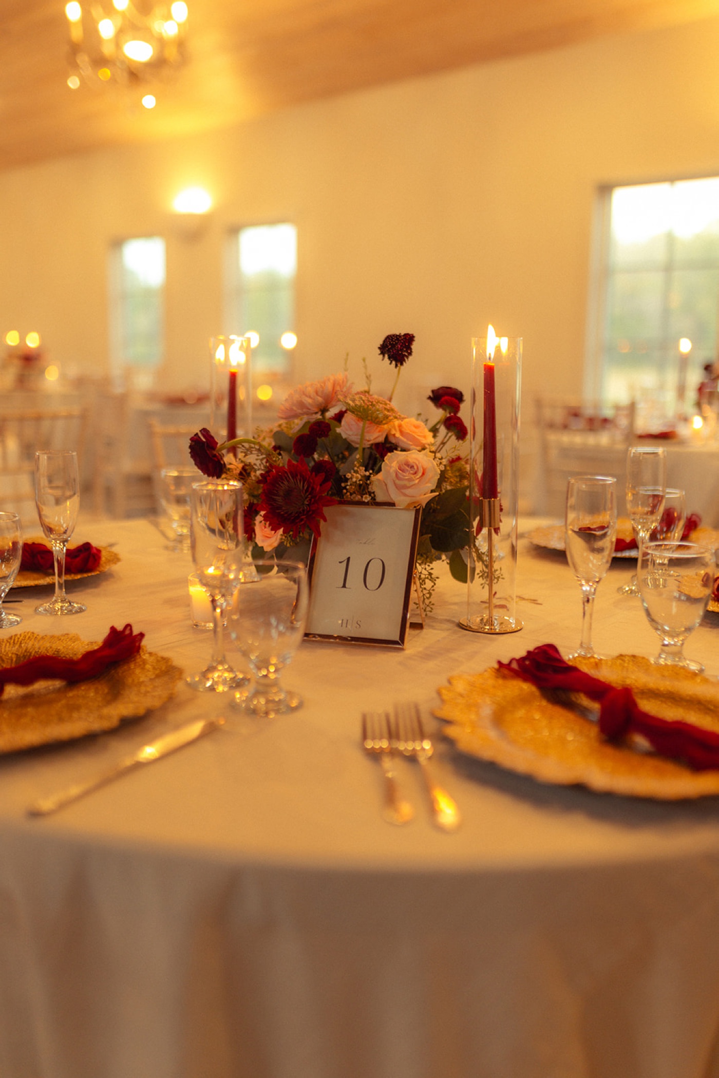 Red and pink floral centerpiece on a table at a Fredericksburg, TX wedding