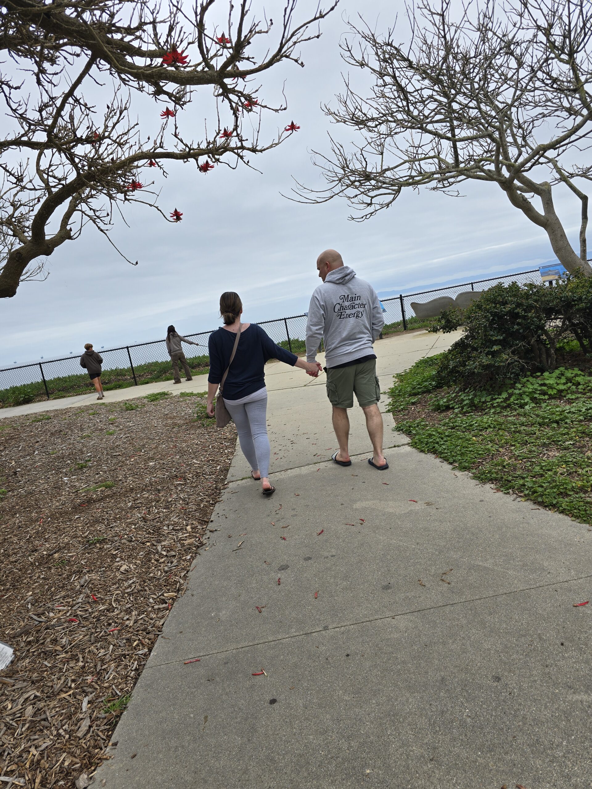 A couple walking down the sidewalk together