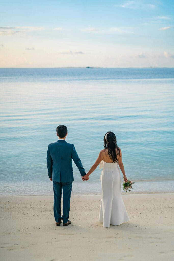 Couple looking out at the beach in the Caribbean before their wedding ceremony
