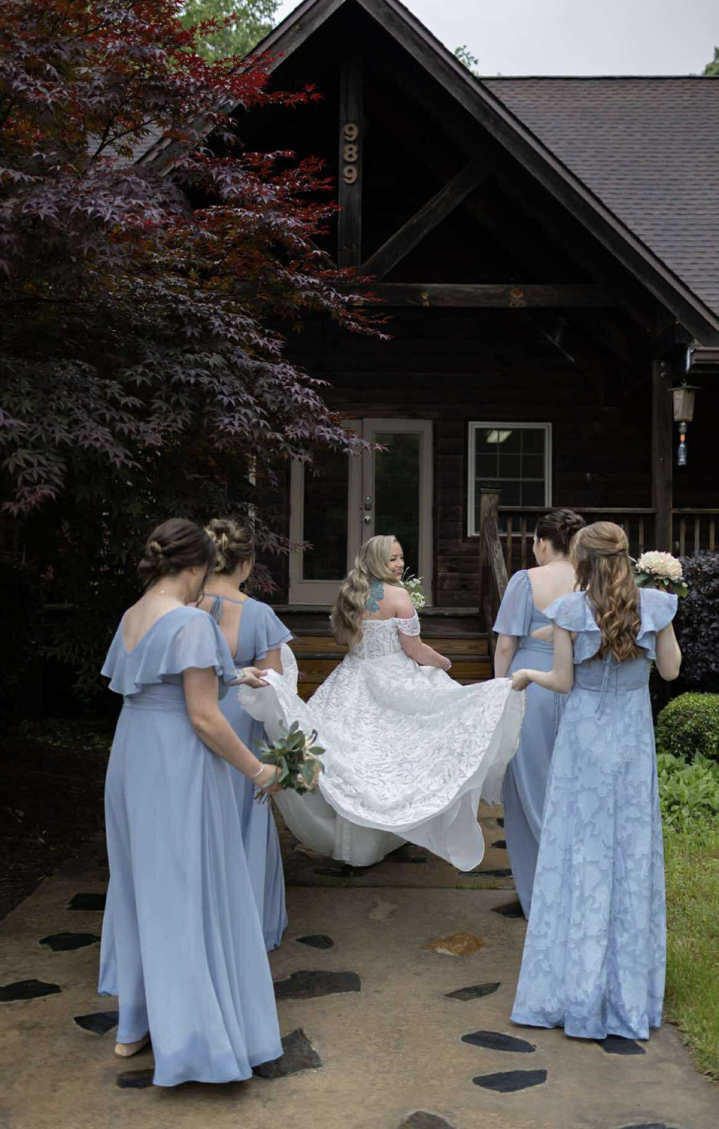 Bridesmaids carrying the train of a bride's dress