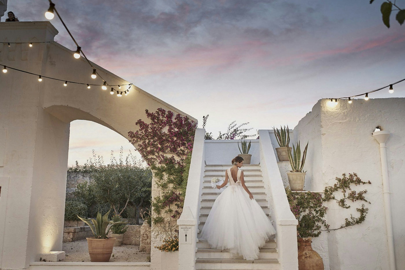 Bride standing on the steps of an Italian villa