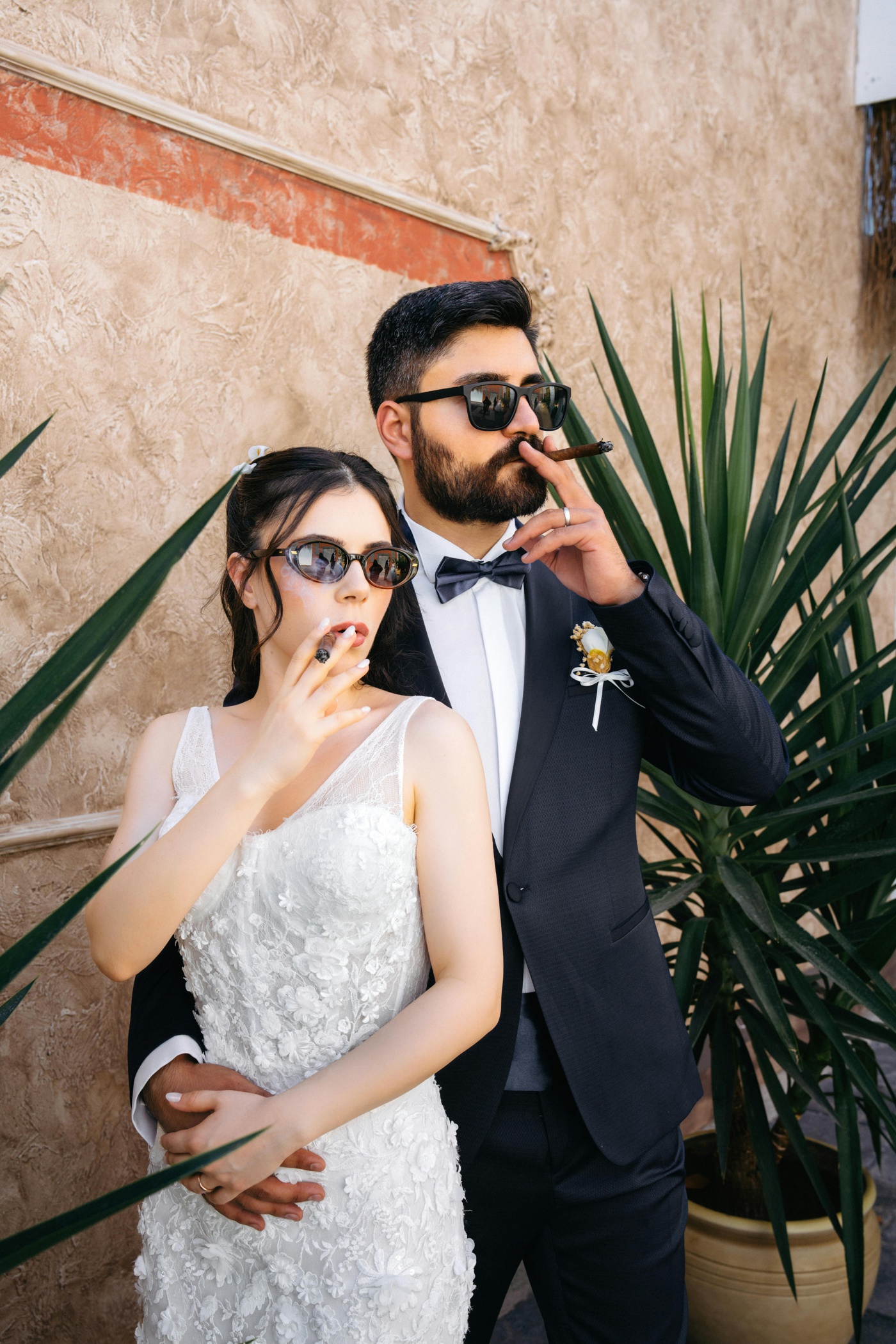 Bride and groom smoking cigars